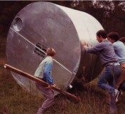 Sangha and family members rolling the first water tank into position